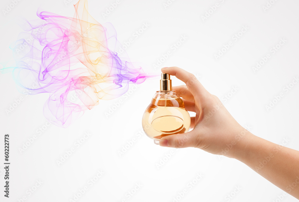 woman hands spraying perfume