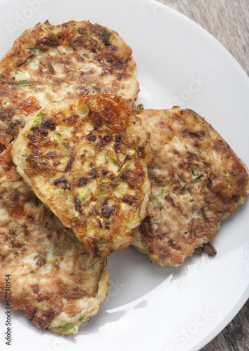 zucchini pancakes on white plate top view