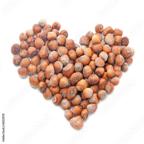 hazelnuts in shape of heart isolated on white