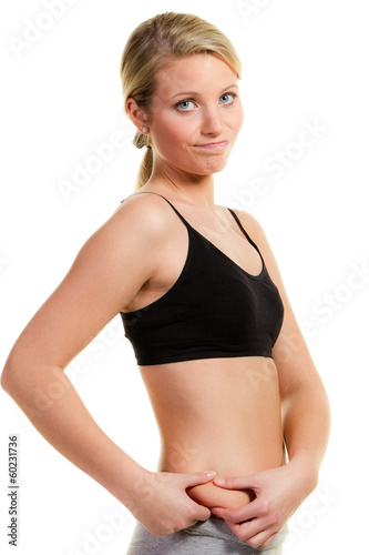 woman grabs her love handles