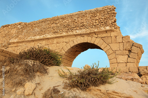 Ancient Roman aqueduct in Ceasarea at the coast of the Mediterra photo