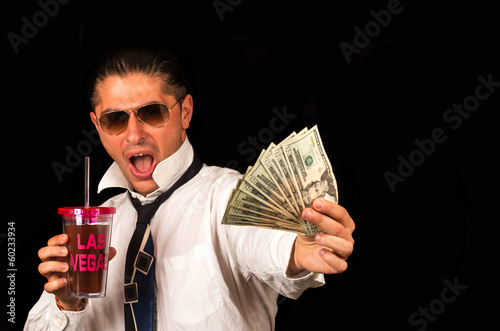 Photography Man drinking a cocktail and showing money