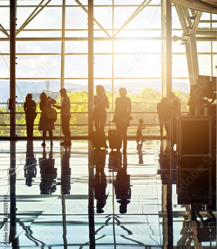 Silhouettes of unrecognizable traveling people at the airport