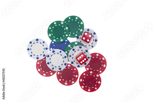 Colorful poker chips with two red dice isolated on white