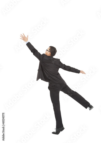 businessman jumping and grabbing over white background