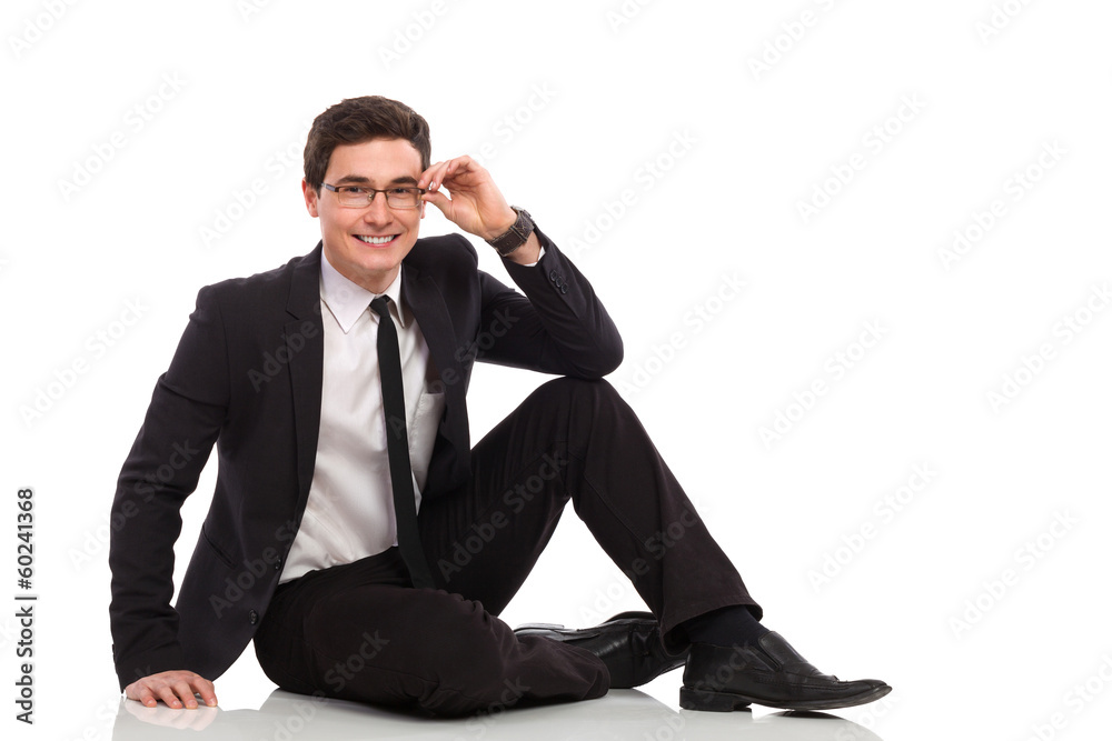 Young businessman sitting on the floor. Young businessman sitting on the floor.