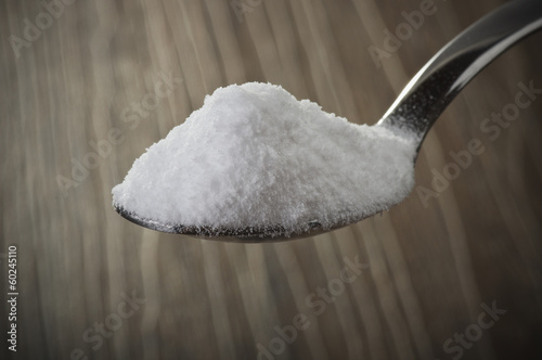 Iron spoon of baking soda close up photo