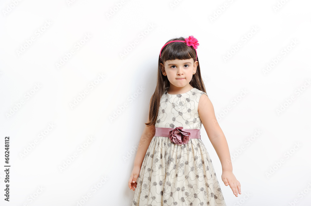 young girl poses for a picture isolated on white. young girl poses for a picture isolated on white.