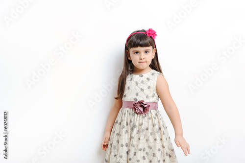 young girl poses for a picture isolated on white.
