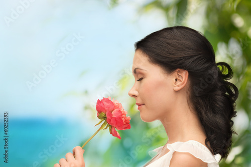 smiling woman smelling flower photo