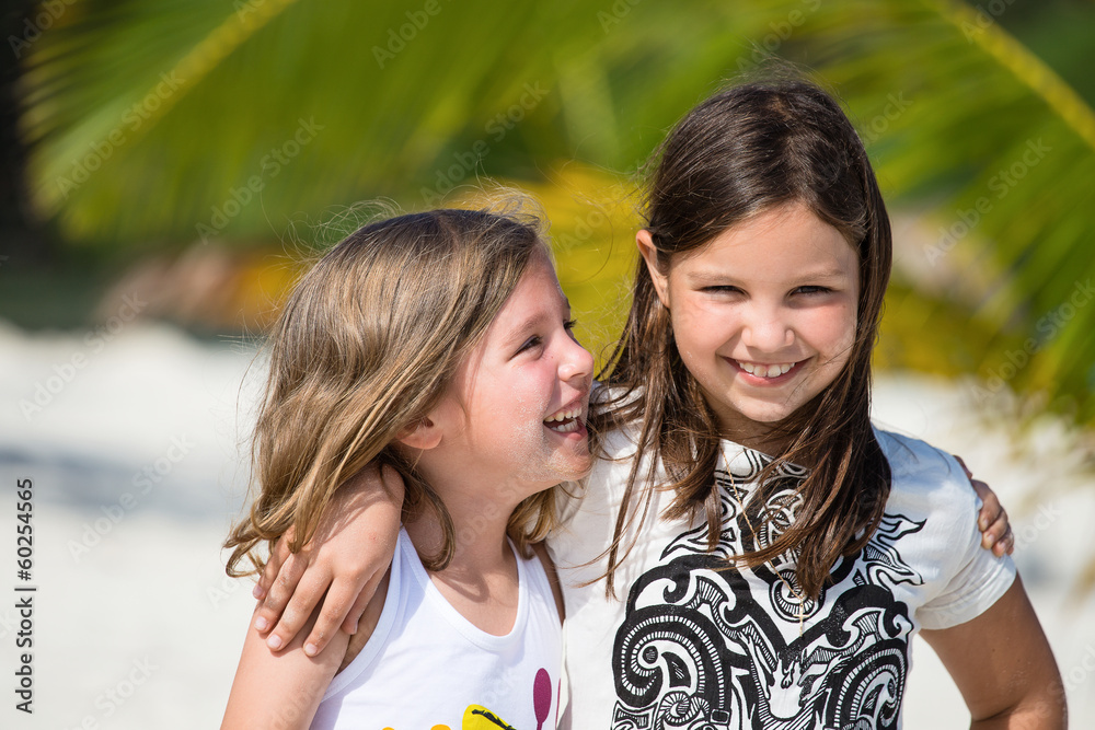 Happy little girls enjoy summer day at the beach Happy little girls enjoy summer day at the beach
