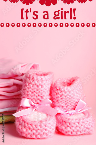Pile of baby clothes on pink background © Africa Studio