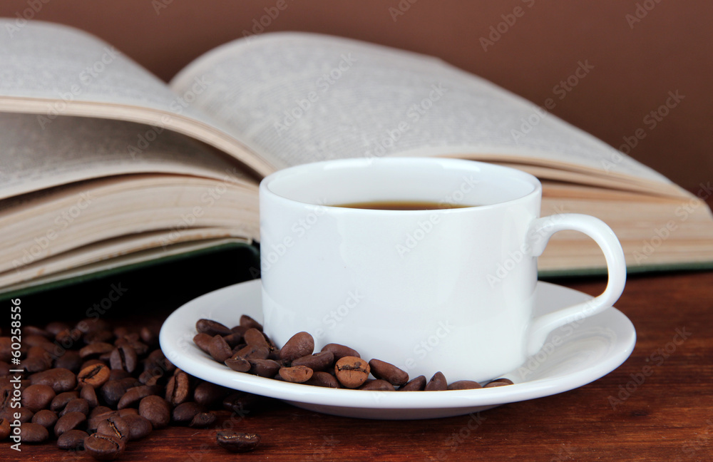 Fototapeta premium Cup of coffee with coffee beans and book