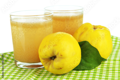 Sweet quince with juice on table on white background