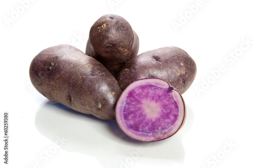 violet potatoes isolated on white background - vitelotte - photo