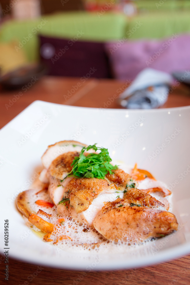 Chicken breast with baby vegetables on plate Chicken breast with baby vegetables on plate