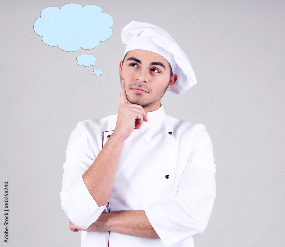Professional chef in white uniform and hat, on gray background Professional chef in white uniform and hat, on gray background