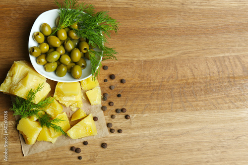 Fototapeta Naklejka Na Ścianę i Meble -  Parmesan cheese, fresh herbs and olives on wooden background