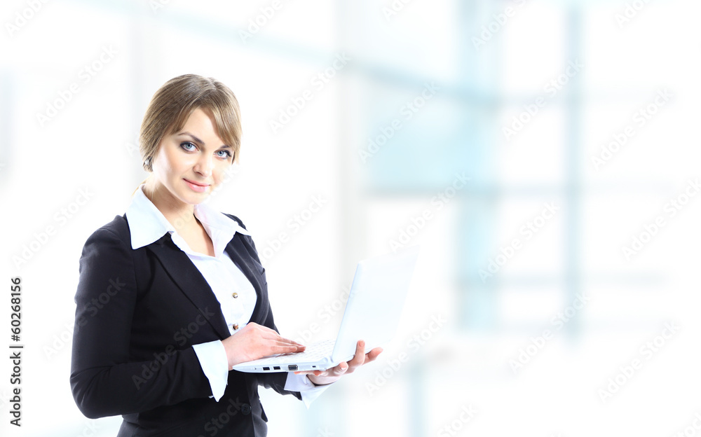 Portrait of a young business woman using laptop at office