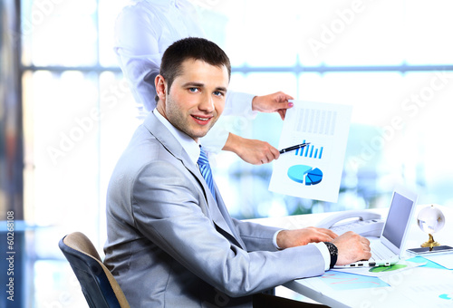 Portrait of cheerful businessman making notes