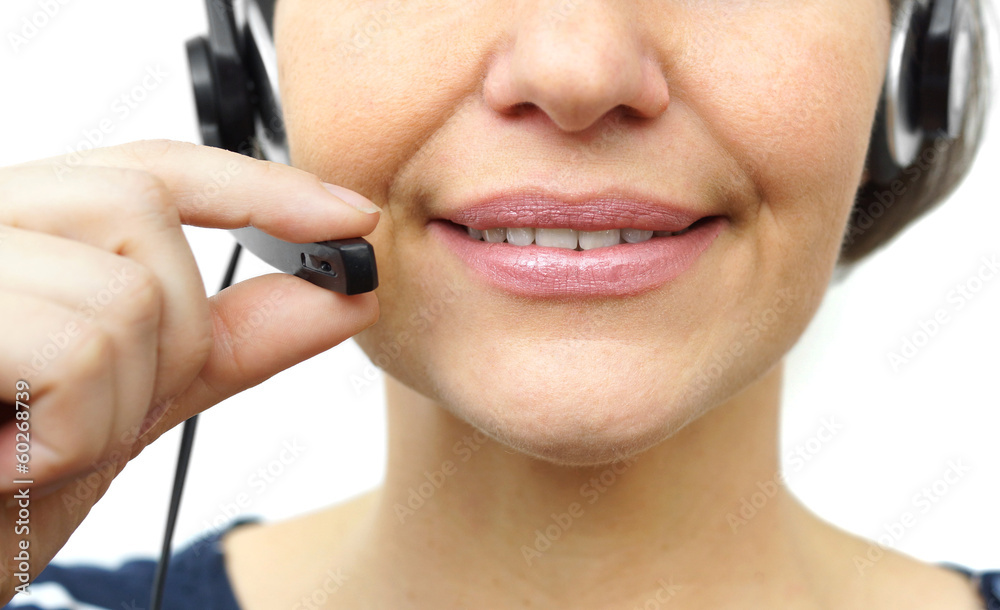 Smiling woman with headphones isolated in call center Smiling woman with headphones isolated in call center