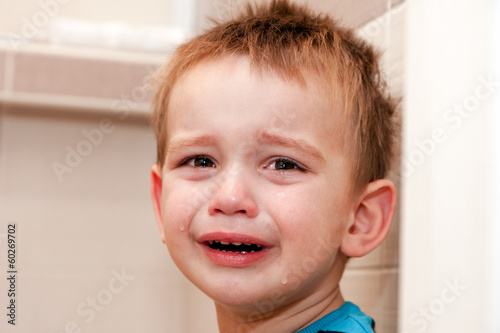 Portrait Of Crying Baby Boy In Home. photo