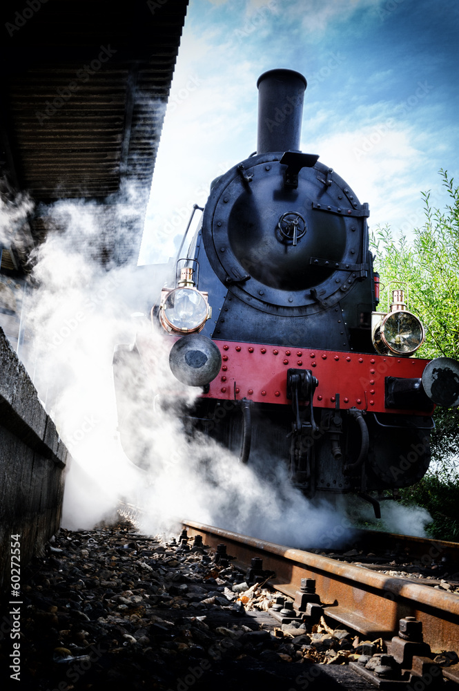 Naklejka premium Historical steam engine train in motion