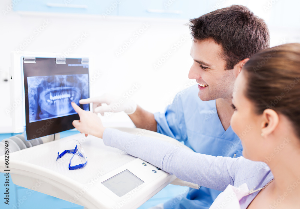 Dentist showing x-rays to patient Dentist showing x-rays to patient