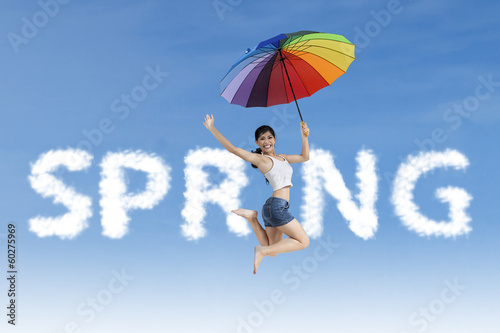 Woman jumps in the spring word