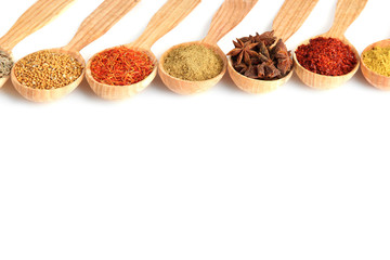Fototapete Gewürze Assortment of spices in wooden spoons, isolated on white  © Africa Studio