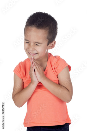 little boy with orange shirt praying