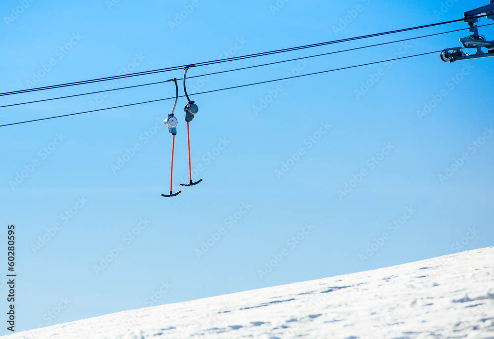 Ski lift system descending from a snowy hill