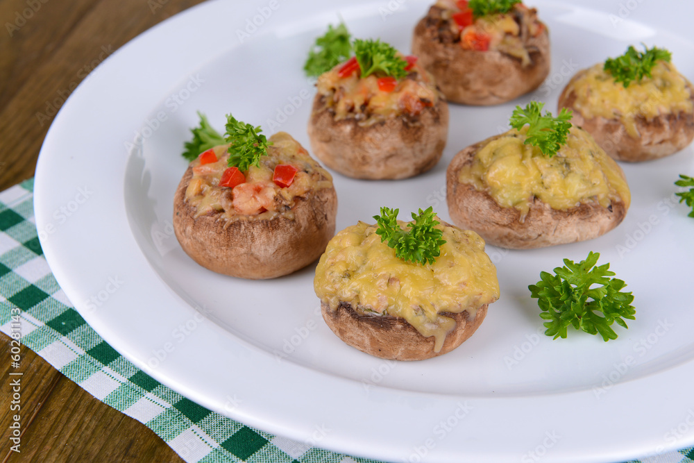 Stuffed mushrooms on plate on table close-up