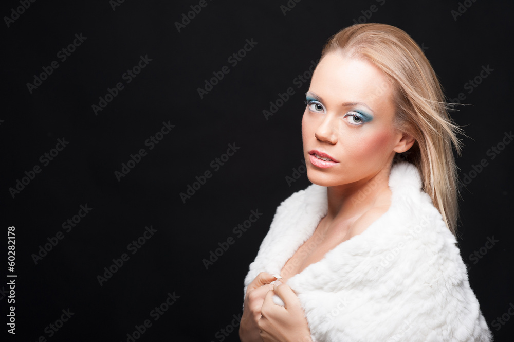 Portrait of attractive blond woman with fur against black backgr Portrait of attractive blond woman with fur against black backgr