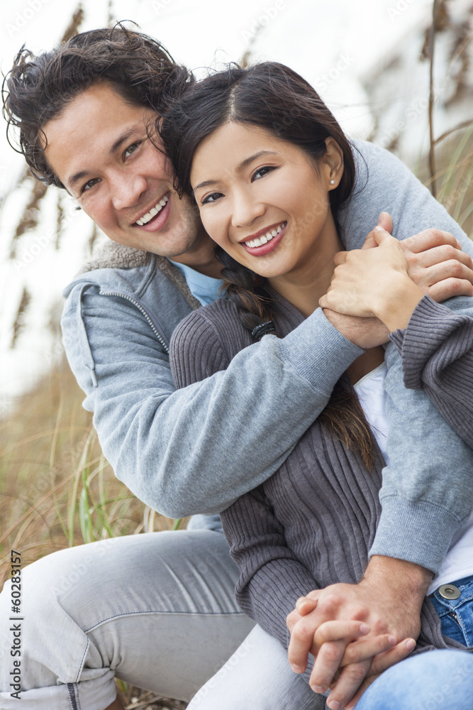 Asian Man Woman Romantic Couple on Beach Dunes Asian Man Woman Romantic Couple on Beach Dunes