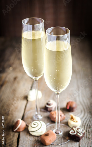 Two glasses of champagne with candies