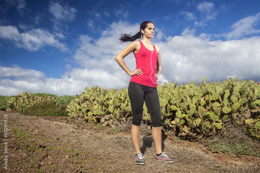 Serious female jogger outdoors looking confident, ready to start Serious female jogger outdoors looking confident, ready to start
