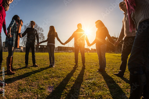 Foto Multiracial Young People Holding Hands in a Circle