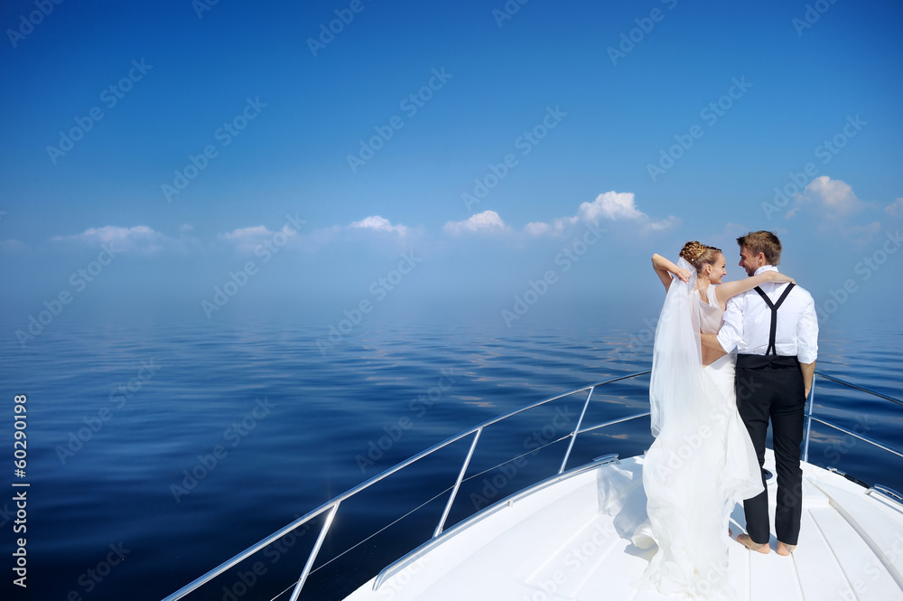 Happy bride and groom on a yacht