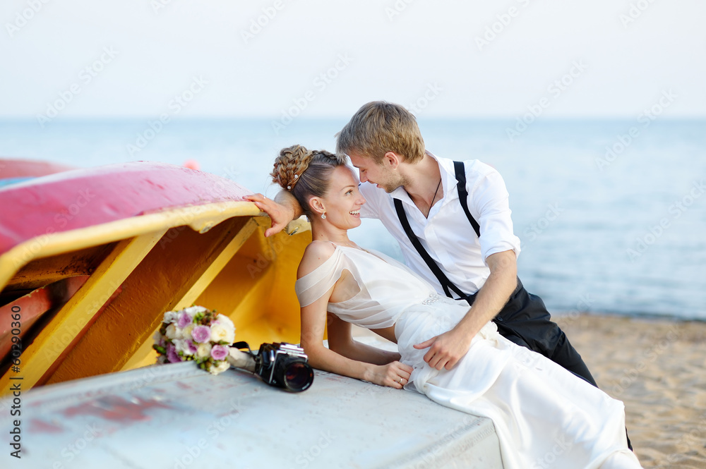 Bride and groom hugging on a beach