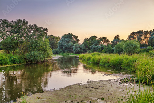Summer sunset around field and river