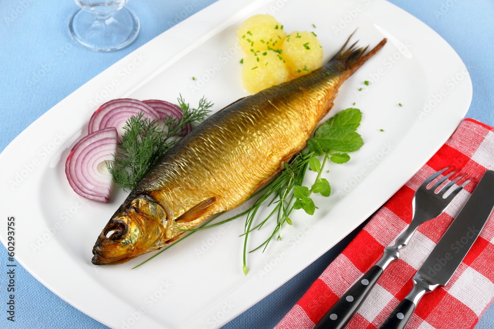 Kippers, smoked herring on a white plate with garnish Kippers, smoked herring on a white plate with garnish