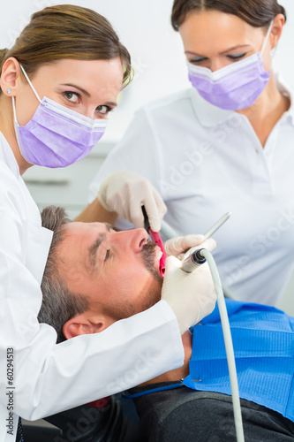 Patient bei Zahnarzt - Behandlung mit Bohren