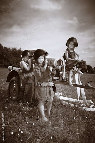Three children in firemen uniforms outdoor © Couperfield