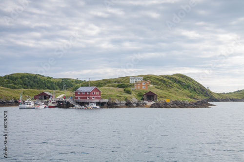View from a boat of houses and small harbor on island in Norther