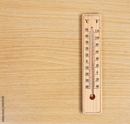 Thermometer on wood background