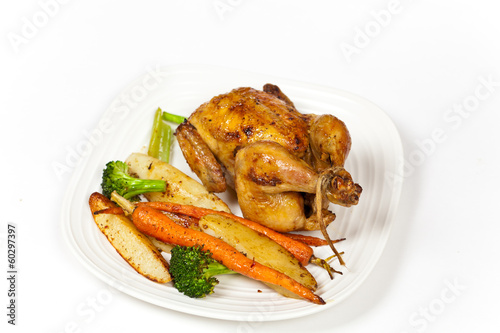 Whole roasted chicken and various vegetables