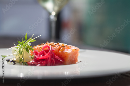 Image of tasty salmon on dish with white vine