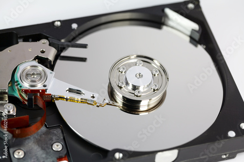 Opened hard disk and screwdriver