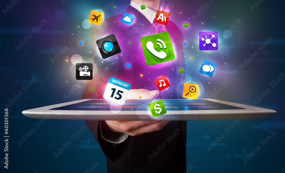 Businessman holding a tablet with modern colorful apps and icons Businessman holding a tablet with modern colorful apps and icons